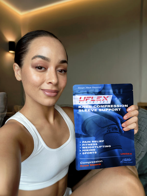 Woman holding a Ulflex knee compression sleeve support package.